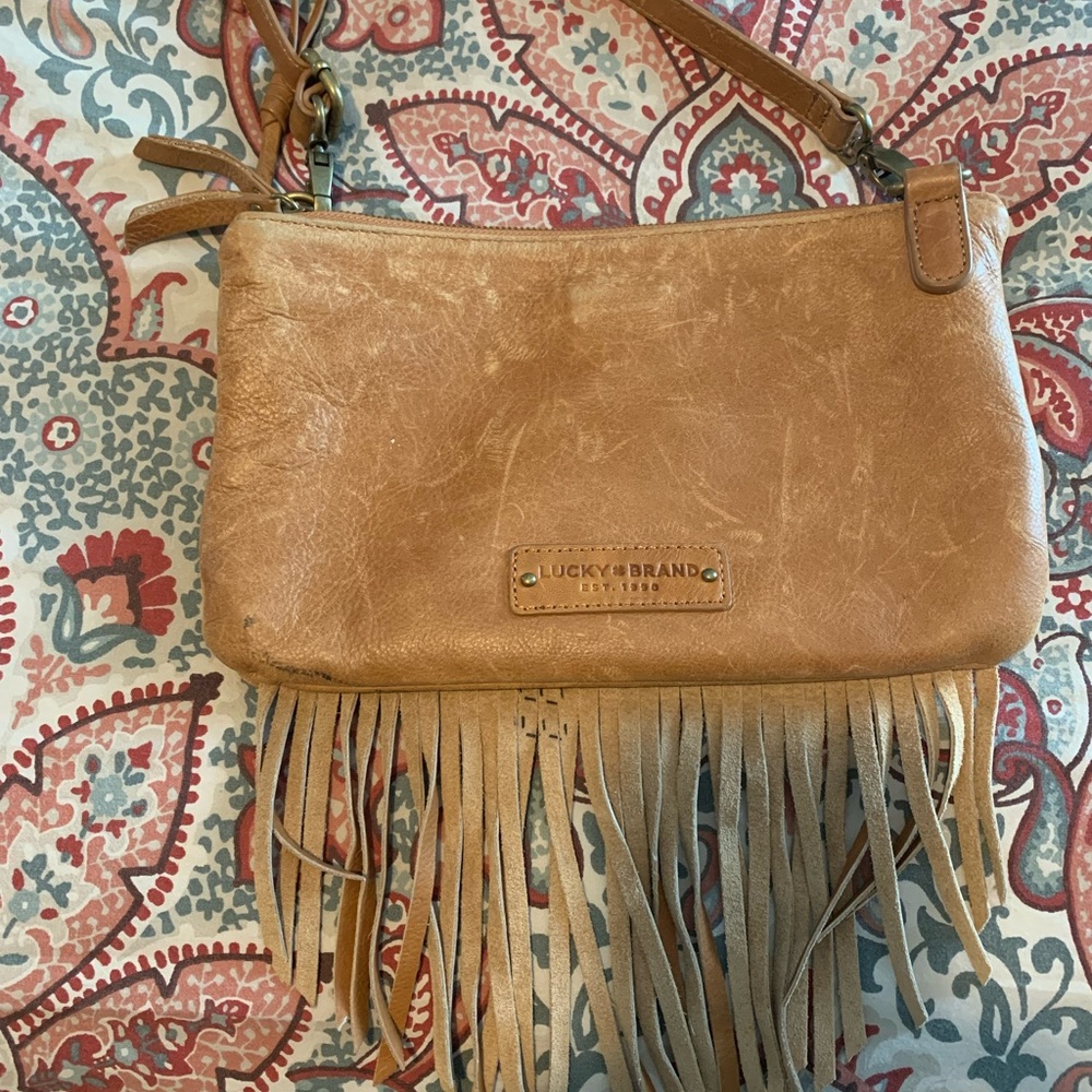 Camel color leather fringe purse. 10x6.5 with three compartments.